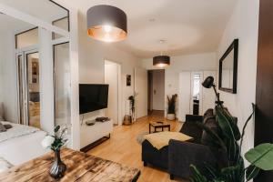 ein Wohnzimmer mit einem Sofa und einem TV in der Unterkunft Stilvolle, gemütliche Wohnung mitten im ZENTRUM in Leipzig