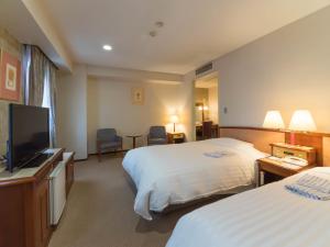 Tempat tidur dalam kamar di Hotel Matsunoka Ichinoseki