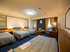 Кровать или кровати в номере Hotel Matsunoka Ichinoseki