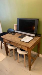 a wooden desk with a computer on top of it at Absolute Center Helsinki Compact Apartment in Helsinki