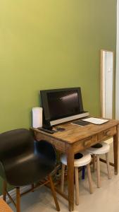 a wooden desk with a computer and a chair at Absolute Center Helsinki Compact Apartment in Helsinki