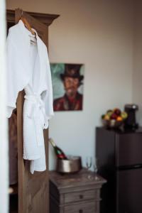 a white shirt hanging on a door in a kitchen at Royal Frenchmen Hotel and Bar in New Orleans