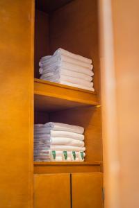 a stack of towels on a shelf in a closet at Akbal Cabañas Boutique in Aguascalientes