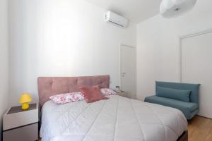 a bedroom with a bed and a blue chair at Design Premium Apartment in Center Milan - HomeUnity in Milan