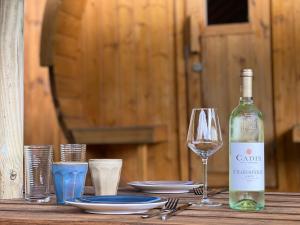 a bottle of wine sitting on a table with a glass at de Harmonie in Molenhoek