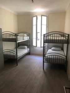 two bunk beds in a room with a window at La Promenade House in Nice