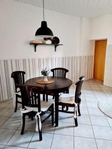 a dining room with a wooden table and chairs at City-Wohnung Salzwedel in Salzwedel