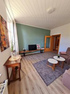 a living room with two tables and a couch at City-Wohnung Salzwedel in Salzwedel