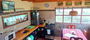 a kitchen with a counter and a sink and a stove at La Ribera - Sepúlveda 191 in El Chalten