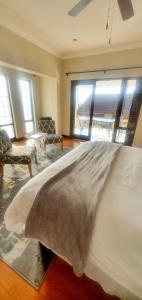 a bedroom with a large bed with a large window at Sun view in Nelspruit