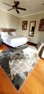 een slaapkamer met een bed en een vloer met een tapijt bij Sun view in Nelspruit