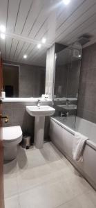 a bathroom with a sink, toilet and bathtub at Old Manor Hotel in Lundin Links