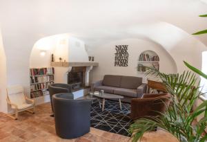 a living room with a couch and a fireplace at Maison du bonheur 10pers Piscine Privee et Chauffee in Grignan