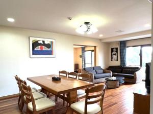 石垣島的住宿－South Sea Ishigaki，客厅配有木桌和椅子
