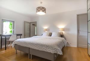 a white bedroom with a bed and a desk at Maison du bonheur 10pers Piscine Privee et Chauffee in Grignan +36 photos