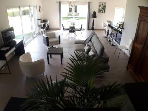 a living room with couches and chairs and a piano at 170 m² entre Lyon et St Etienne in Saint-Martin-la-Plaine