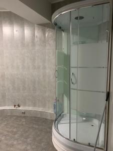 a shower with a glass door in a bathroom at Almaty Backpackers in Almaty +38 photos