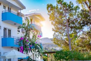 a building with flowers on the side of it at Golden Lighthouse Hotel in Patara
