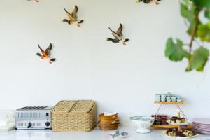 a white wall with birds on the wall at Golden Lighthouse Hotel in Patara