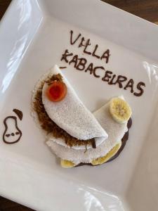 a white plate topped with a sandwich with a banana at Villa Kabaceiras in Tatajuba