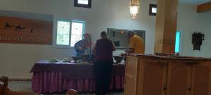 Un groupe de personnes debout autour d'une table dans une pièce dans l'établissement Maison Vallée Du Ziz, à Oulad Aïssa