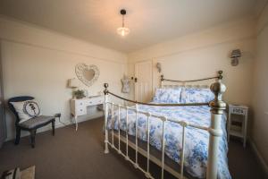 a bedroom with a bed and a chair and a desk at Treblenick House in Thirsk