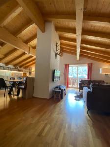 a large living room with a couch and a table at Alpin Resort Kaprun 14 in Kaprun