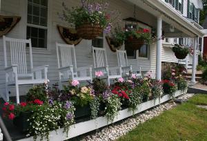 
a garden filled with lots of flowers next to a building at Christmas Farm Inn and Spa in Jackson
