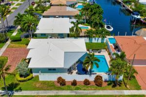 an aerial view of a house with a large white roof at Salt Life Beach Cottage Sleeps 8 Heated Pool in Pompano Beach