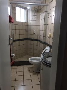 a small bathroom with a toilet and a shower at Rio Quente - DiRoma in Rio Quente