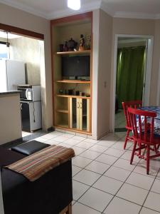 a kitchen with red chairs and a table and a counter at Rio Quente - DiRoma in Rio Quente