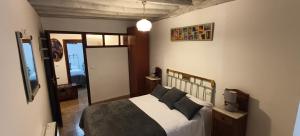 a bedroom with a bed with pillows on it at Casa de la Cigüeña in Candelario