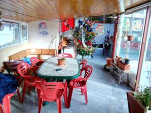 a dining room with a table and chairs and a christmas tree at Vila Marcela in Buşteni