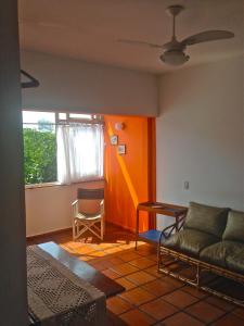 a living room with a couch and a table at Guarujá Apartment in Guarujá