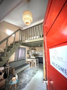 een woonkamer met een trap en een rode deur bij Loft Baler with Kitchen & Ideal for Work from Home Setup in Baler
