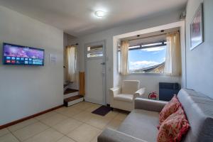 sala de estar con sofá y ventana en Departamento con vista al lago en Bariloche. en San Carlos de Bariloche