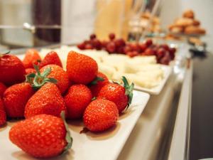 a bunch of strawberries on a counter with other desserts at Zalamera BnB in Valencia