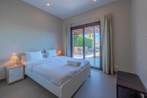 a bedroom with a bed and a large window at 3BR Family Villa in Sabina, El Gouna. Lagoon & Private Pool in Hurghada +47 photos