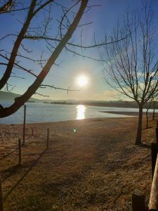 a beach with the sun setting over the water at Casa do Terreiro in Macedo de Cavaleiros