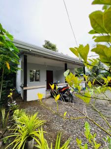 a house with a motorcycle parked in front of it at Loft Baler with Kitchen & Ideal for Work from Home Setup in Baler