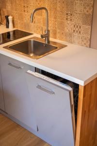 a kitchen with a sink and a counter top at Apartament Różana 21 in Poznań