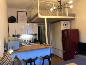 a kitchen with a counter and stools in a room at Design District Area - Compact Apartment Helsinki Center in Helsinki