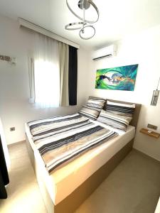 a bedroom with a large bed with a chandelier at Villa Lifestyle & Trends in Limenaria