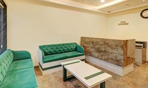 a living room with a couch and a table at Treebo Delmont in Chandīgarh