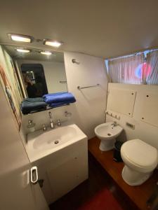 a bathroom with a sink and a toilet and a mirror at Johnny M Yacht in Taʼ Xbiex
