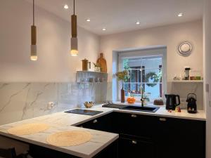 a kitchen with a sink and a counter top at Apartament Na Krzywym Kole in Kazimierz Dolny +84 photos