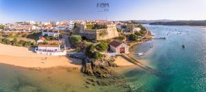 an aerial view of a beach with boats in the water at Sunshine Patio Getaway in Vila Nova de Milfontes