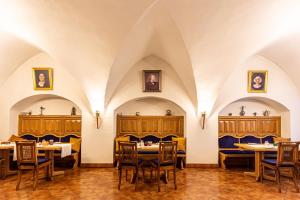 a restaurant with tables and chairs in a room with arches at Das Büttner in Schneeberg