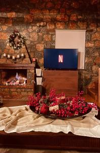 a table with a tray of food in front of a fireplace at Chalet D'elite in Palaios Agios Athanasios