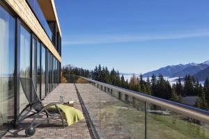 a balcony with a chair on the side of a building at Alpengasthof Filzstein in Krimml